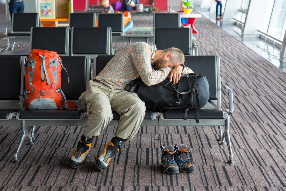 tired traveller at airport needs sleep